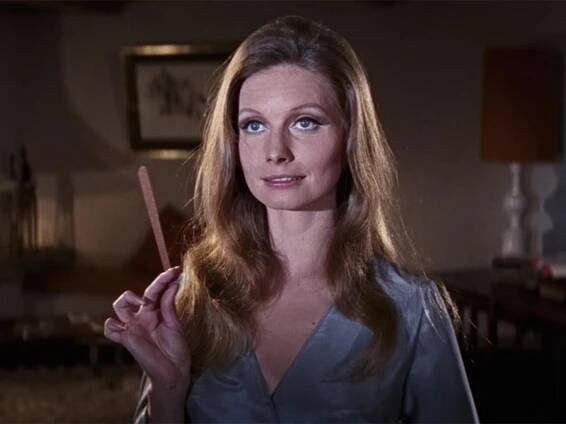 Catherine Schell holding a stick