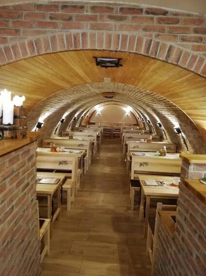 a long tunnel with tables in a restaurant at Rodinný wellness hotel U Langrů in Dolní Věstonice