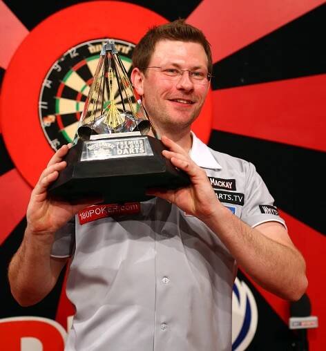 James Wade holding the Premier League Darts trophy.