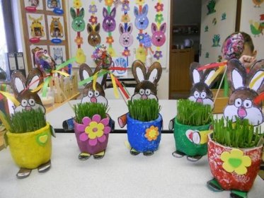 several pots with fake grass in them and some bunny ears sticking out of the top