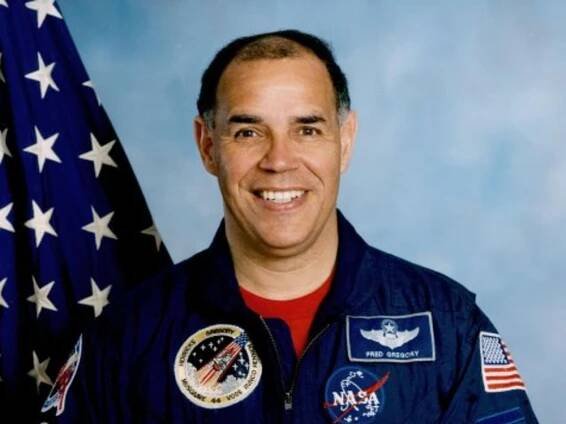 Portrait of Frederick Gregory, a middle aged African American man in a NASA flight suit. 