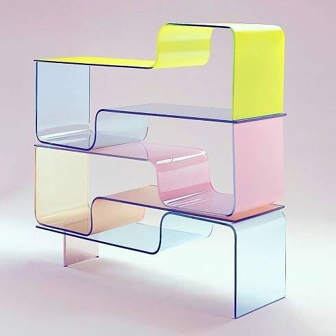 a stack of different colored chairs sitting next to each other on top of a table
