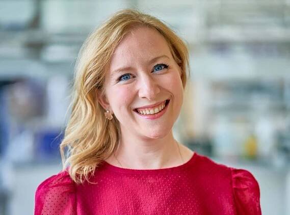 Dr. Sarah Stern smiling, wearing a red top