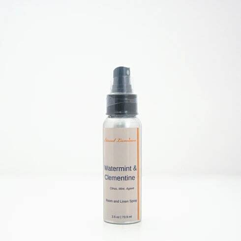 A 2.5oz Watermint & Clementine room & linen spray sitting against a white background made by Eternel Luminen.