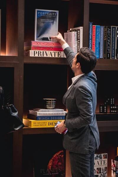Alex at work curating the mammoth bookcase at 277 Fifth Avenue