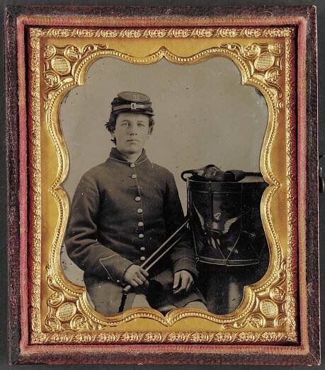 [Young George Wingate Weeks of Company D, 8th Maine Infantry Regiment with drum in front of painted backdrop showing shoreline