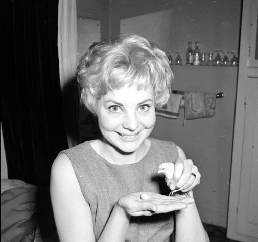 Black and white photo of Barbara Ferris holding a small bird.