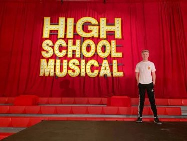 Caption: The High School Musical cast dancing and singing in a memorable scene Wallpaper