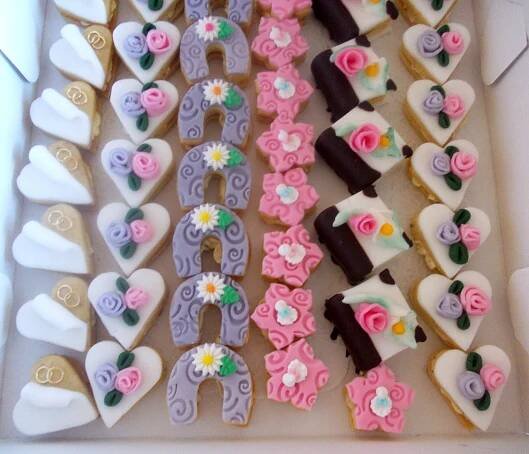 a box filled with lots of decorated cookies