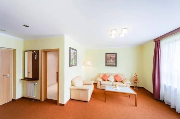a living room with a couch and a table at Golf Hotel Austerlitz in Slavkov u Brna