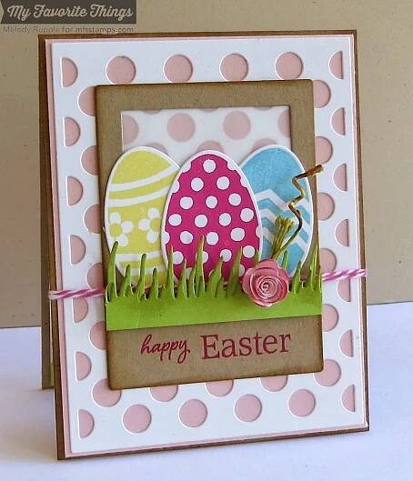 an easter card with eggs in the grass and pink polka dots on it, sitting on a table