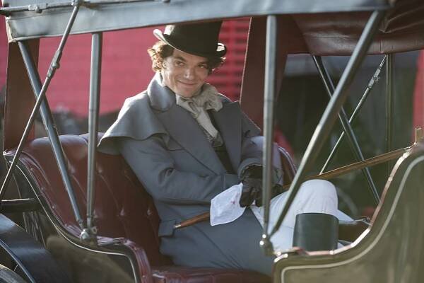 Edward Bluemel as Billy McGee, sitting in an 1800s carriage, in 'Washington Black.'