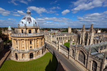 Radcliffe Camera and All Souls College in Oxford, England against a blue sky