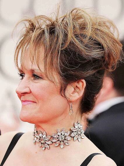 Lorraine Ashbourn wears a silver flower choker necklace.