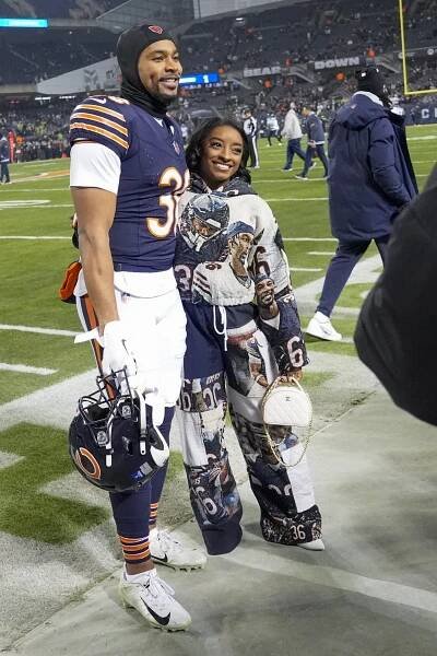 Simone Biles and Jonathan Owens at a football game.