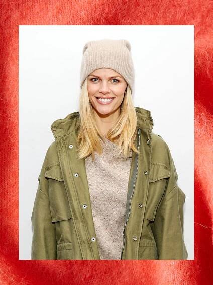 brooklyn decker in a beanie and green jacket