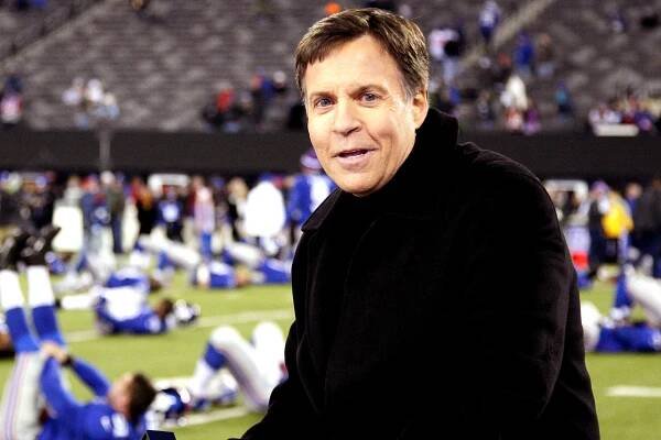 Bob Costas sits on the set before the start of a Giants game against the Cowboys
