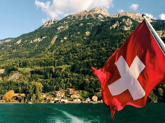 The Swiss flag flies from a boat on Brienzersee.