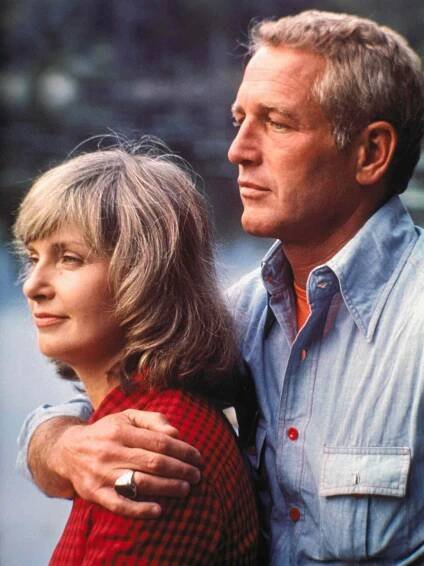 Paul Newman and his wife, actress Joanne Woodward shown on location for a television special. Slide shows full length view of the two.