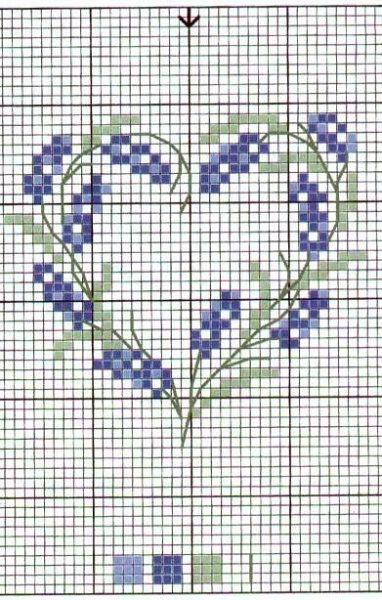 a cross stitch heart with blue flowers on it