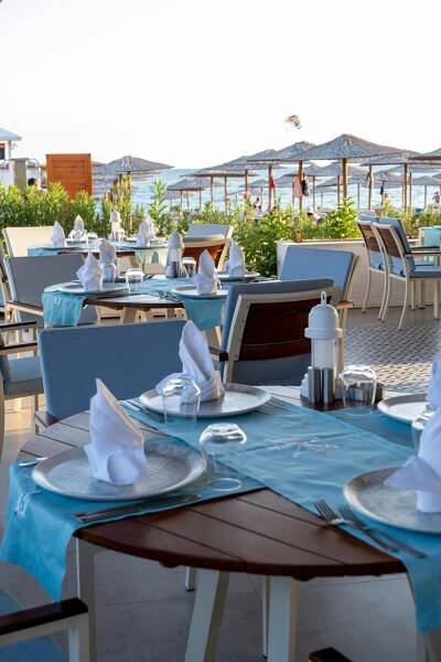 a table with a blue table cloth and white napkins at Ducale Lara - Ultra All Inclusive in Lara