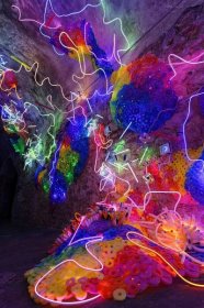 a colorful installation with thin lights woven throughout