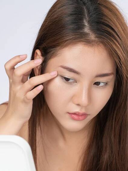Closeup portrait of young gorgeous asian woman looking in the mirror worry about pimple on her face. Beauty care for skin problem , acne concept. Topless girl teen stock images, royalty-free photos and pictures