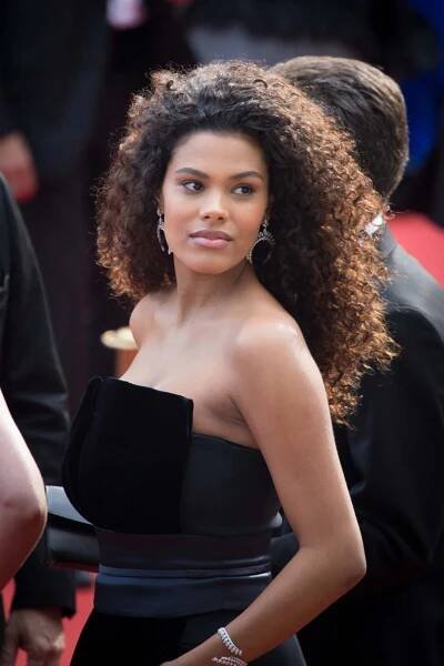 Tina Kunakey in a black dress