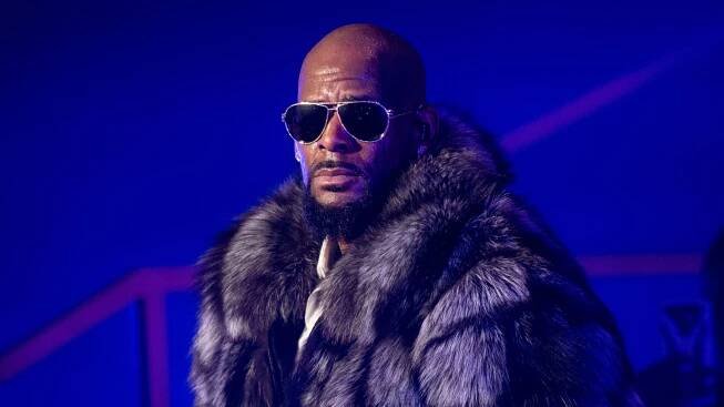 R. Kelly turns himself in to Chicago police after being indicted on sexual abuse charges