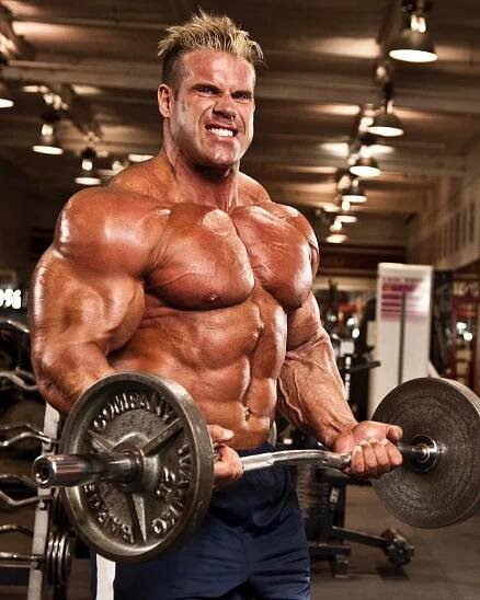 a man is posing for the camera while holding a barbell