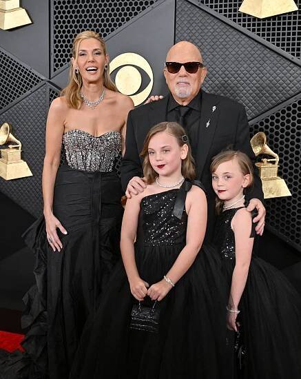 Billy Joel, Alexis Roderick, and their two daughters at the 66th Grammy Awards.