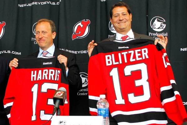 Joshua Harris and David Blitzer pose for a photo after buying the Devils in 2013.