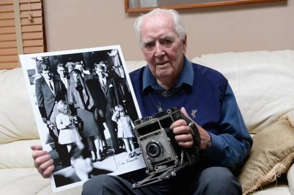 Dan Farrell, of Long Island, holds another historic photo taken from a different angle that he took for the New York Daily News