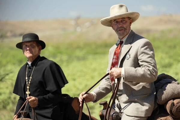 Sebastian Roche as Father Renauld and Jamie McShane as Marshall Thomas 