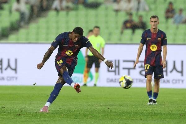Marcus Rashford of FC Barcelona kicking a soccer ball.