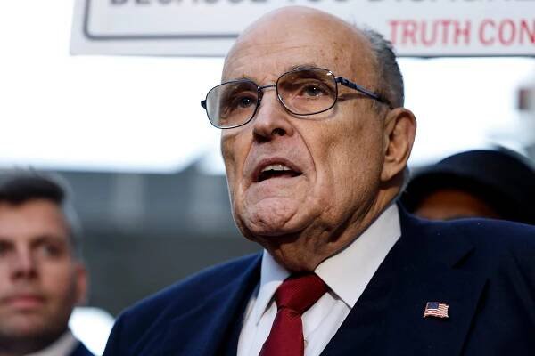 Former Mayor of New York Rudy Giuliani talks to reporters as he leaves after his defamation trial, where a jury awarded $148 million in damages to two former Georgia election workers.
