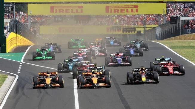 Lando Norris, McLaren MCL38, leads Max Verstappen, Red Bull Racing RB20, Oscar Piastri, McLaren MCL38, Charles Leclerc, Ferrari SF-24, Carlos Sainz, Ferrari SF-24, and the rest of the field at the start during the Hungarian GP at Hungaroring on Sunday July 21, 2024 in Budapest, Hungary. 