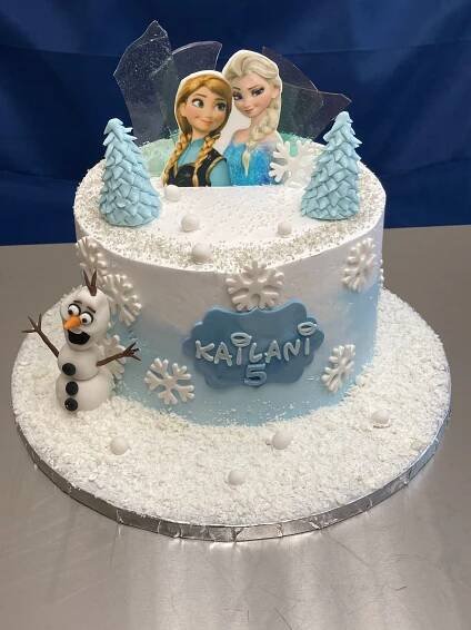 there is a cake that has frosting on it with frozen princess and snowman decorations