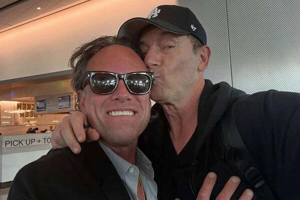 Jason Isaacs Hints at Rumored 'White Lotus' Cast 'Beef' as He Plants a Kiss on Costar Walton Goggins