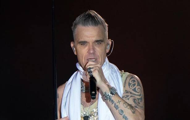Robbie Williams performing live on stage