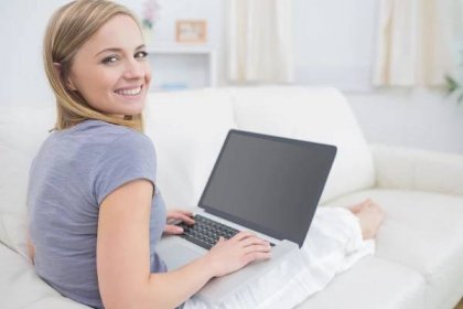 Portrét příležitostné ženy používat přenosný počítač v obývacím pokoji — Stock Fotografie © Wavebreakmedia #24113029