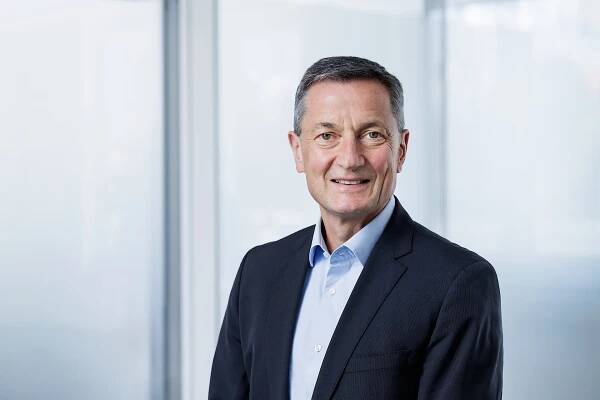 Hans-Werner Kaas in a suit against a light background.