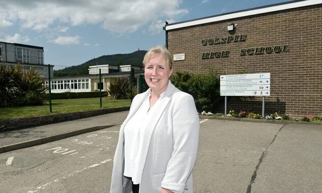 Catherine Brown in a white bouse and light-coloured jacket standing outside Golspie High School