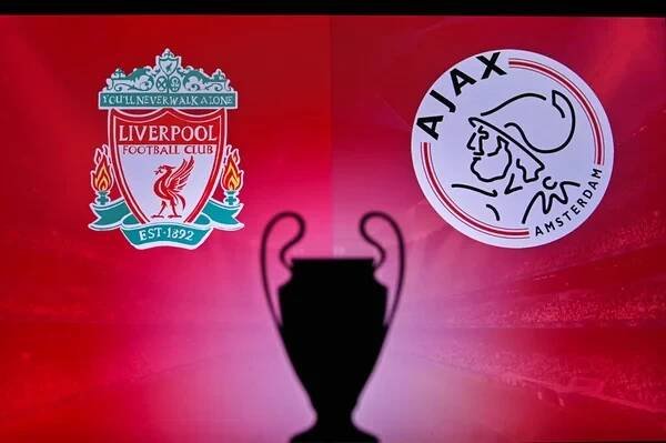 NYON, SWISS, NOVEMBER2. 2020: Liverpool vs. Ajax Amsterdam. Fotbal Liga mistrů UEFA 2021 Group Stage zápas. UCL Trophy silueta, znamení klubu na obrazovce v pozadí — Stock obrázek