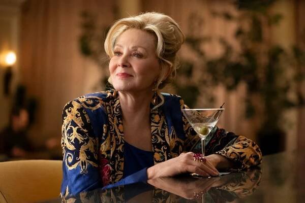 Jean Smart, in character as Deborah, sits at a counter with a martini.