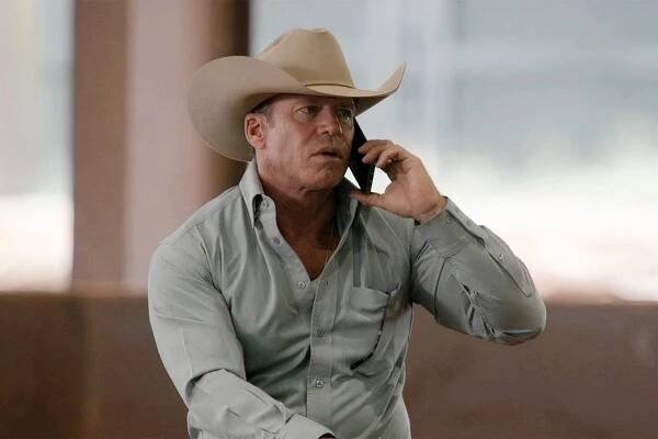 Taylor Sheridan as Travis in "Yellowstone" talking on the phone. 