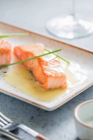 Beurre blanc sauce served atop cooked salmon