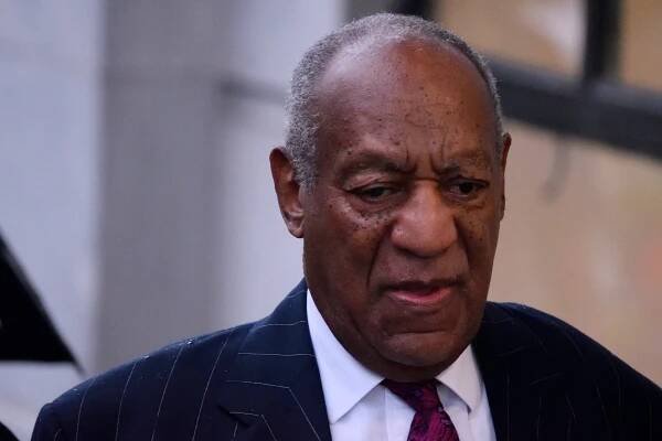 Image may contain Bill Cosby Tie Accessories Accessory Human Person Face Head Coat Suit Clothing and Overcoat