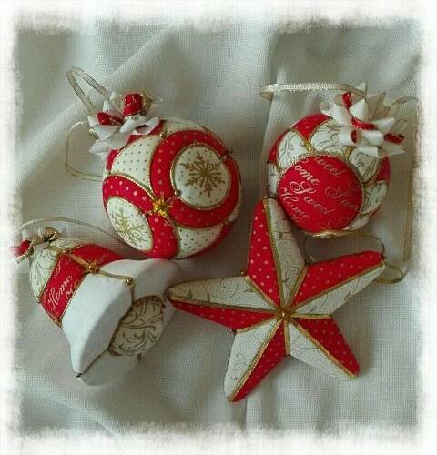 three red and white ornaments on a white cloth