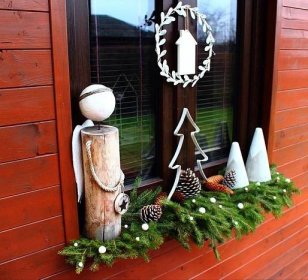a window sill decorated with pine cones and ornaments